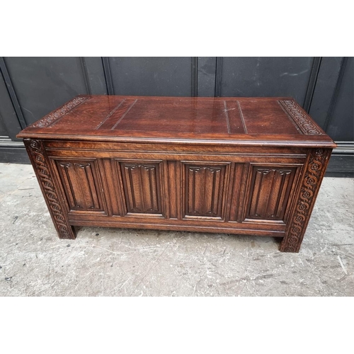 1127 - A reproduction oak linenfold coffer, 106.5cm wide.