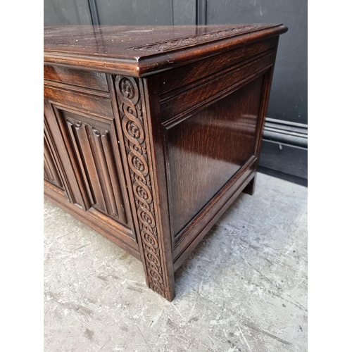 1127 - A reproduction oak linenfold coffer, 106.5cm wide.