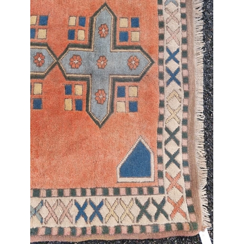 1355 - A Persian rug, having four geometric medallions, with geometric borders, 208 x 137cm.... 