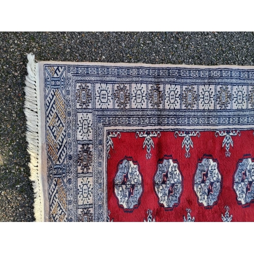 1361 - A modern Bokhara rug, on red and cream ground, 193 x 126cm.