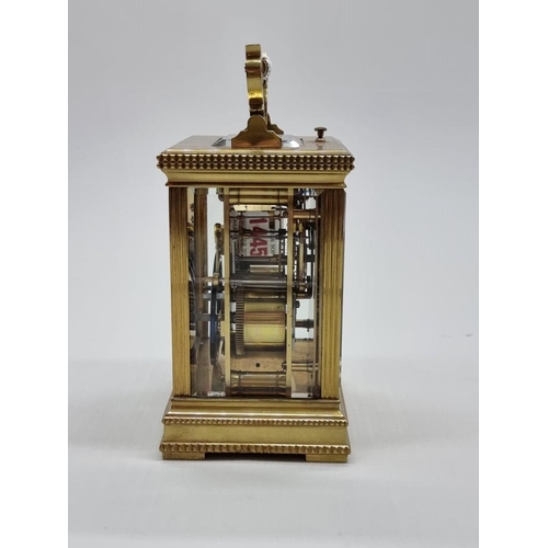 1445 - A good antique brass carriage clock, with push button repeat and gong strike, height including handl... 