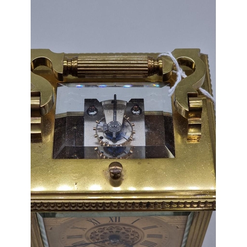 1445 - A good antique brass carriage clock, with push button repeat and gong strike, height including handl... 