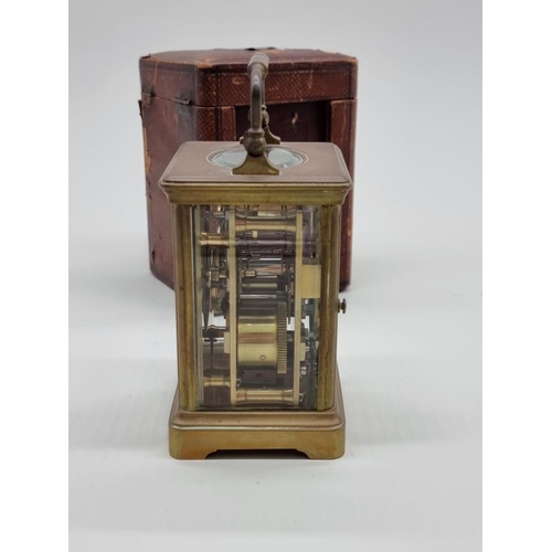 1454 - An antique brass carriage timepiece, height including handle 15cm, with winding key and leather trav... 