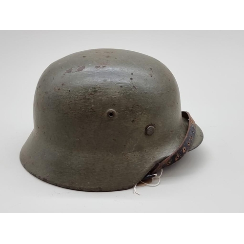 1465 - A World War II German M-35 helmet. 