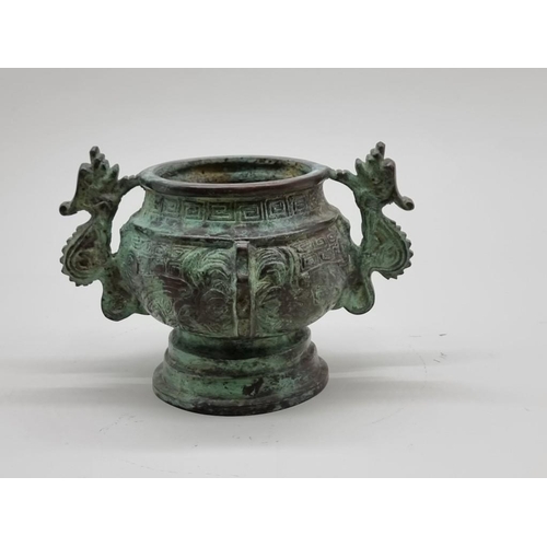 1476 - A Chinese bronze twin handled censer, in Archaistic style, 18cm wide.