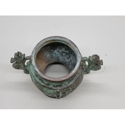 1476 - A Chinese bronze twin handled censer, in Archaistic style, 18cm wide.