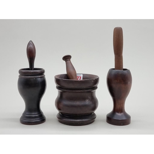 1477 - Three antique treen mortars, largest 13cm high, with three pestles.