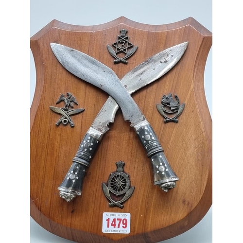 1479 - A Gurkha diorama, with two small kukris and related badges, on walnut easel back shield, 29cm high.... 