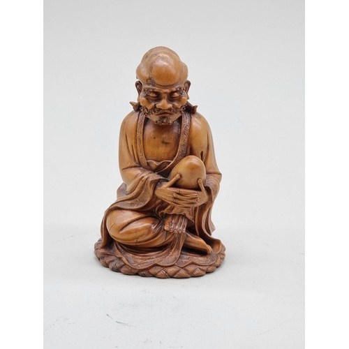 1485 - A good Chinese carved wood seated figure, 19th century, 15cm high.