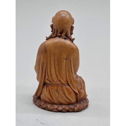 1485 - A good Chinese carved wood seated figure, 19th century, 15cm high.