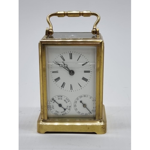 1526 - A good 19th century French brass calendar carriage clock, with subsidiary dials for date and da... 