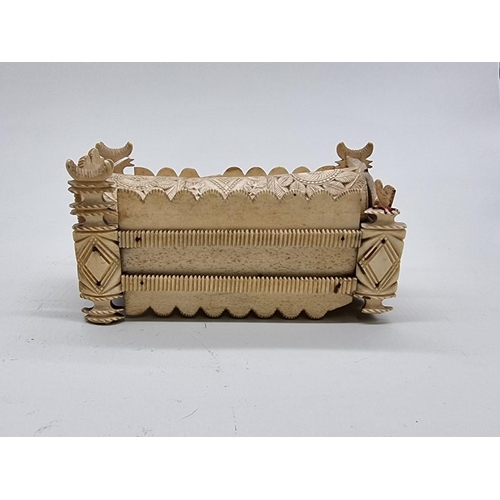 1533 - A Napoleonic prisoner-of-war carved bone sarcophagus form domino box, the inner cover of pierced cri... 