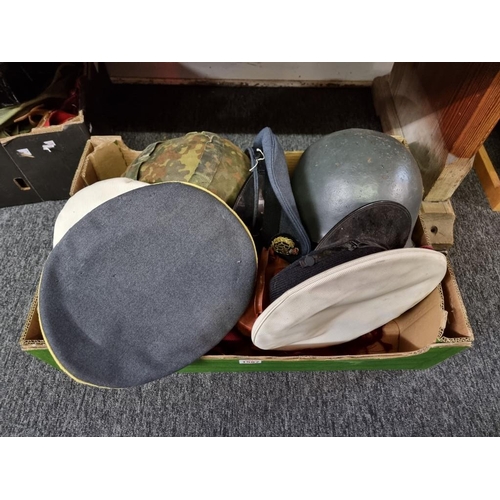 1587 - A collection of assorted military items, to include: helmets; and Royal Navy officer's caps. ... 