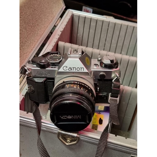 1559 - Cameras: a Canon AE-1 35mm, with Canon FD 50mm 1:8 S.C. lens; together with further 1:5.5 f=300mm le... 