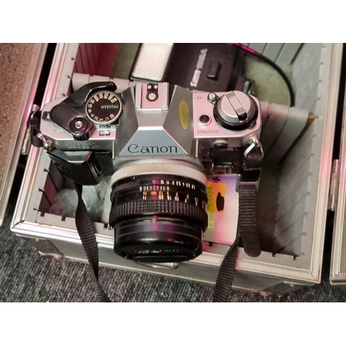 1559 - Cameras: a Canon AE-1 35mm, with Canon FD 50mm 1:8 S.C. lens; together with further 1:5.5 f=300mm le... 