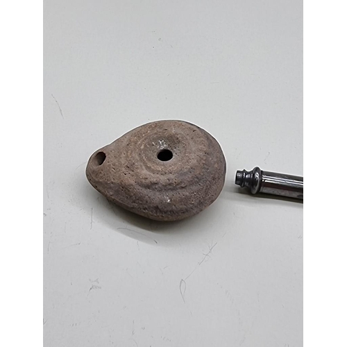 1626 - A small Roman pottery oil lamp, 6cm wide; together with a white metal propelling pencil, 14cm e... 