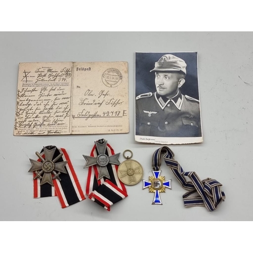 1643 - Medals: a group of WWII German medals, together with a letter and a postcard. (6)