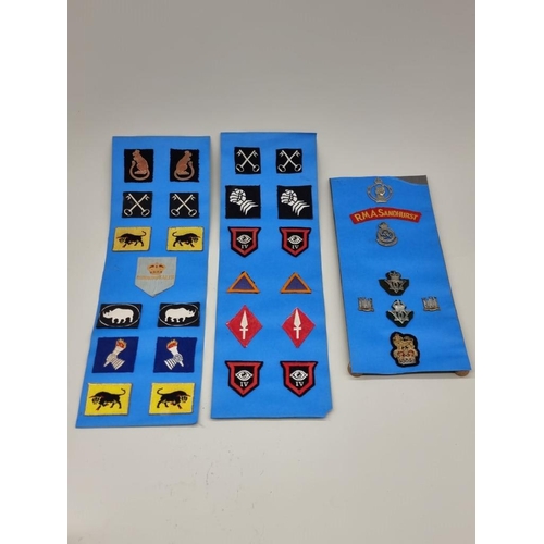 1653 - A collection of British military badges and similar, on three card display boards.... 