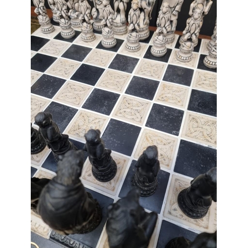 1678 - A large resin chess set, king 19cm, pawn 10.7cm; together with similar 55cm chessboard.... 