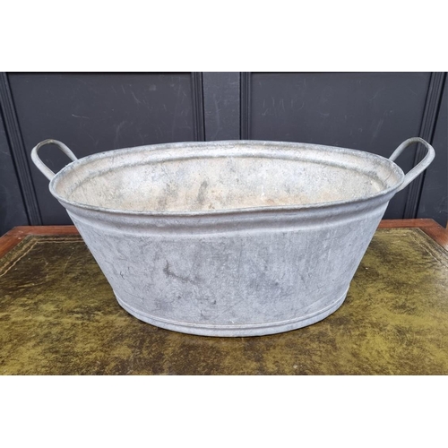 1689 - An old twin handled galvanized child's bath, 69cm wide.