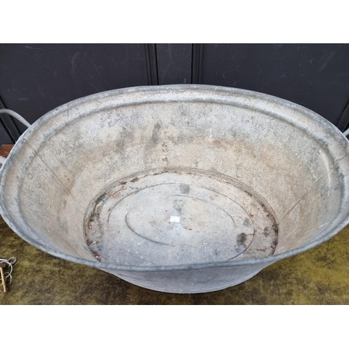 1689 - An old twin handled galvanized child's bath, 69cm wide.