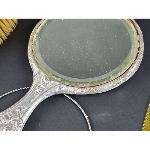 113A - Four silver mounted dressing table items, comprising a hand mirror, two hairbrushes and a comb.... 