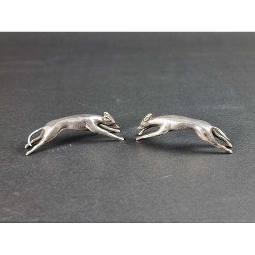 120 - A pair of silver plated greyhounds, 8.5cm long.