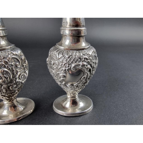 125 - A pair of Victorian silver pepperettes, by Samuel M Levi, Birmingham 1899, 9.5cm high, 71g.... 