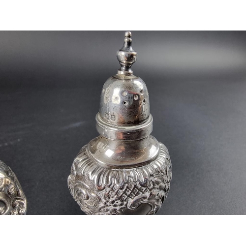 125 - A pair of Victorian silver pepperettes, by Samuel M Levi, Birmingham 1899, 9.5cm high, 71g.... 