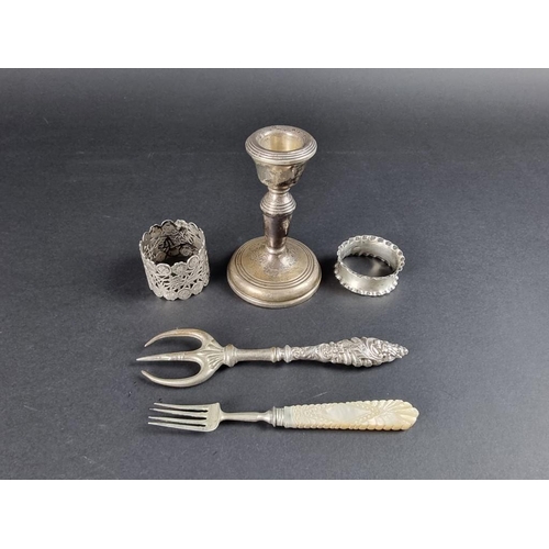 131 - A group of silver and white metal items, to include: a weighted candle holder, by W I Broadway &... 