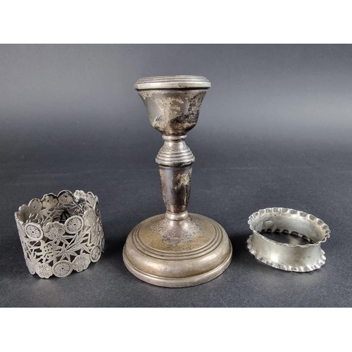 131 - A group of silver and white metal items, to include: a weighted candle holder, by W I Broadway &... 