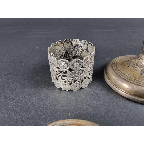 131 - A group of silver and white metal items, to include: a weighted candle holder, by W I Broadway &... 