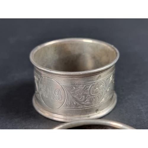 134 - A small group of silver, comprising two small twin handled trophy cups; a pair of silver napkin ring... 