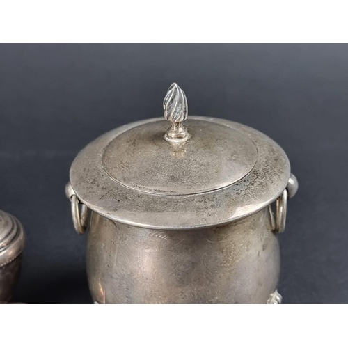 142 - Four silver items, comprising: a small pepperette; a circular bowl; a cauldron shaped sugar box and ... 