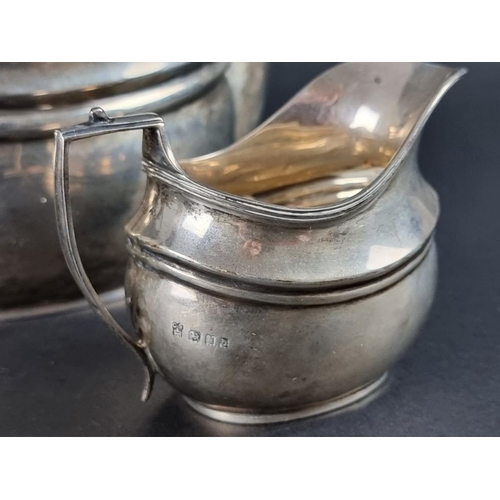 145 - A Georgian style silver three piece tea set, by C S Harris & Sons Ltd, London 1919 and 1921, the... 