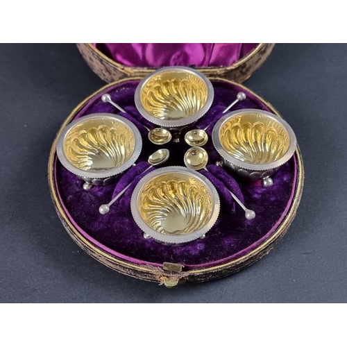 148 - A cased set of four Victorian silver salts with matching spoons, by Harwood, Plante & Harrison, ... 