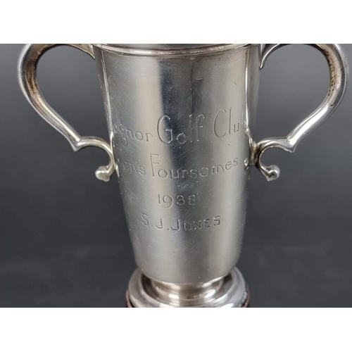 161 - A silver twin handled golfing trophy cup, having two male figures to lid, by Asprey & Co Ltd, Lo... 