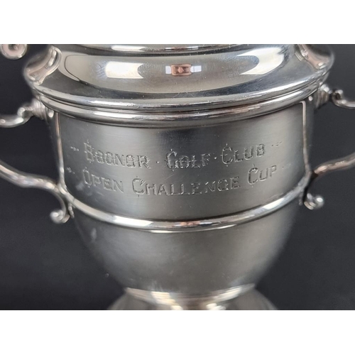 164 - A silver twin handled golfing trophy cup, by Atkin Brothers, Sheffield 1938, 14cm high, on socle, 27... 