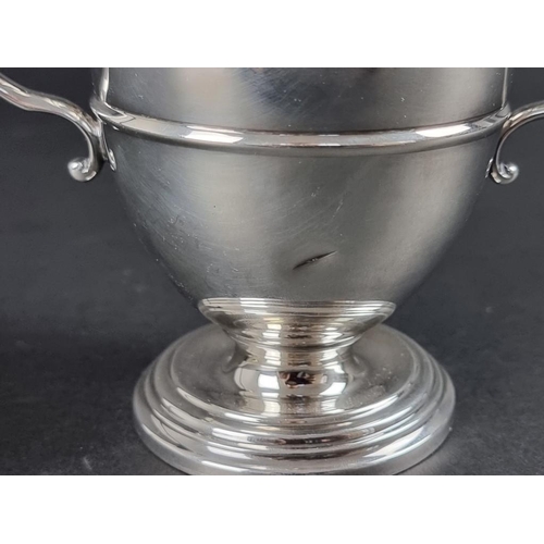 164 - A silver twin handled golfing trophy cup, by Atkin Brothers, Sheffield 1938, 14cm high, on socle, 27... 