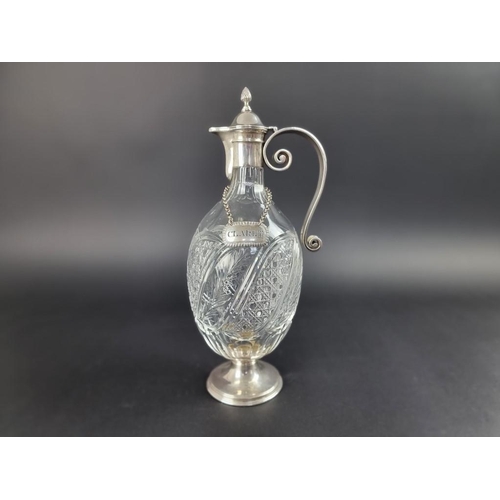 182 - A silver mounted cut glass claret jug, by Edward Barnard & Sons Ltd, London 1911, 34cm high; tog... 