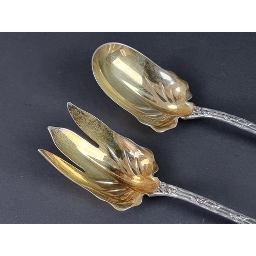 198 - A pair of Tiffany & Co 'Wavy Edge' pattern Sterling silver and parcel gilt salad servers, 25.5cm... 