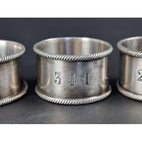 206 - Three Cunard EPNS napkin rings; together with a similar White Star lines example. (4)... 