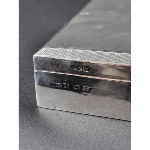 23 - A silver engine turned cigarette box, by Walker & Hall, Birmingham 1955, 14.5cm wide.... 