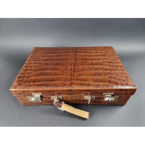 230 - A vintage crocodile skin dressing case, with partial silver fitting, by Goldsmiths & Silversmith... 