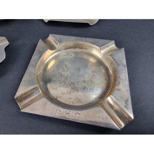 235 - Five various silver ashtrays; together with a small silver Armada dish, 261g.