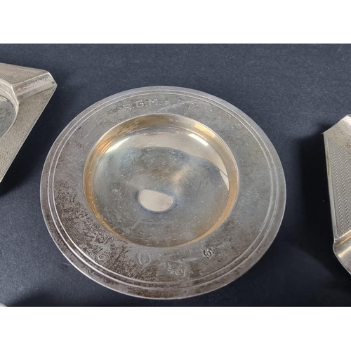 235 - Five various silver ashtrays; together with a small silver Armada dish, 261g.