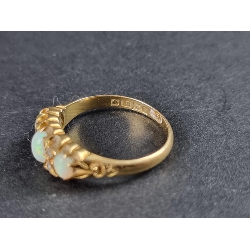 238 - An 18ct gold opal three stone ring, interspersed with four small old cut diamonds, hallmarked Birmin... 