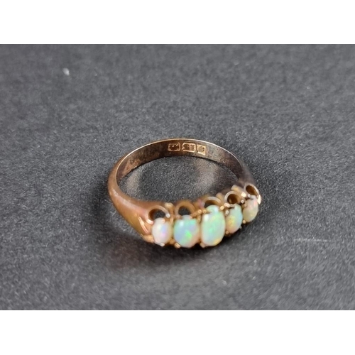 239 - An opal five stone ring, in an unmarked setting, size M.