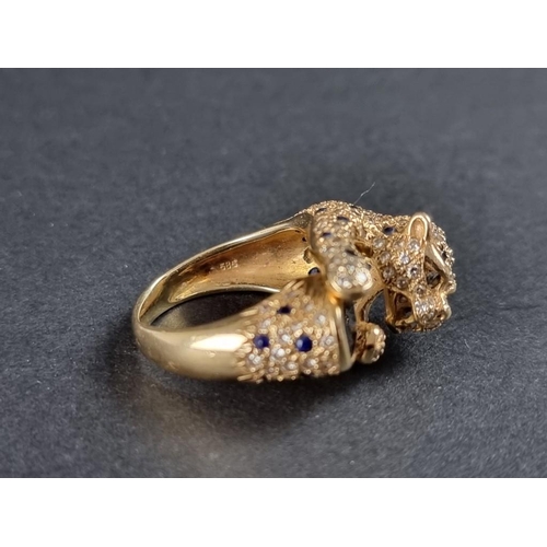 248 - A Cartier style yellow metal panther ring, encrusted with diamonds and sapphires, stamped 14k/585, s... 