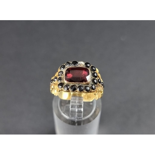 255 - A George IV 18ct gold mourning ring, set with a faceted garnet and jet beads, inscribed 'Charlotte J... 